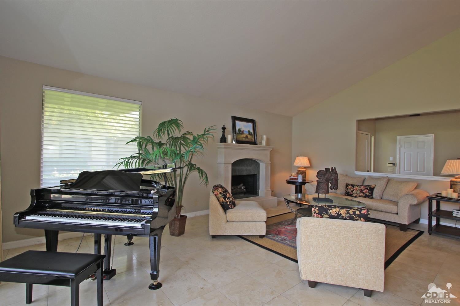 198 Ranch View Circle Palm Desert, CA 92211 - Photo 7 of 54 a living room with furniture a fireplace and a piano