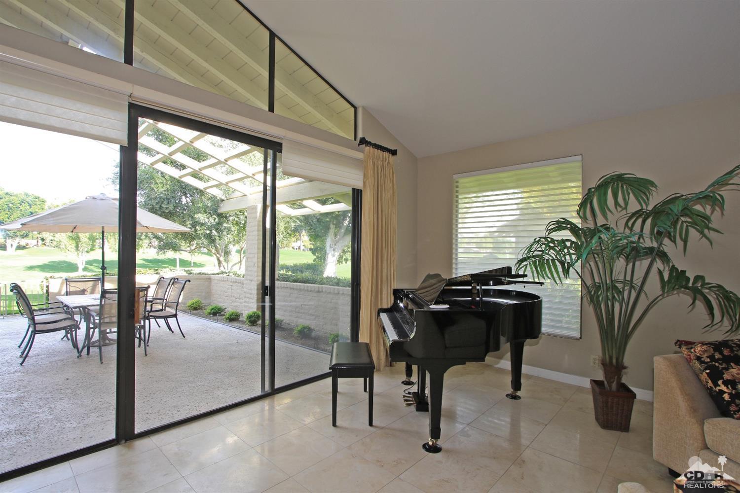 198 Ranch View Circle Palm Desert, CA 92211 - Photo 10 of 54 a living room with furniture and a floor to ceiling window