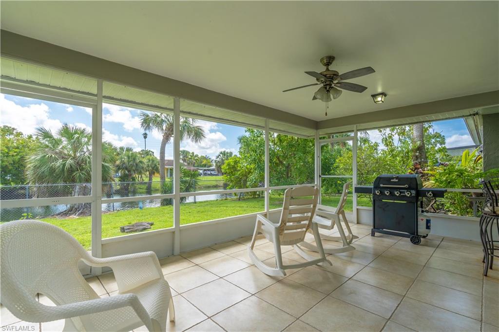 2100 55th Street Southwest Naples, FL 34116 - Photo 46 of 50 a view of a dining room with furniture water view and a floor to ceiling window