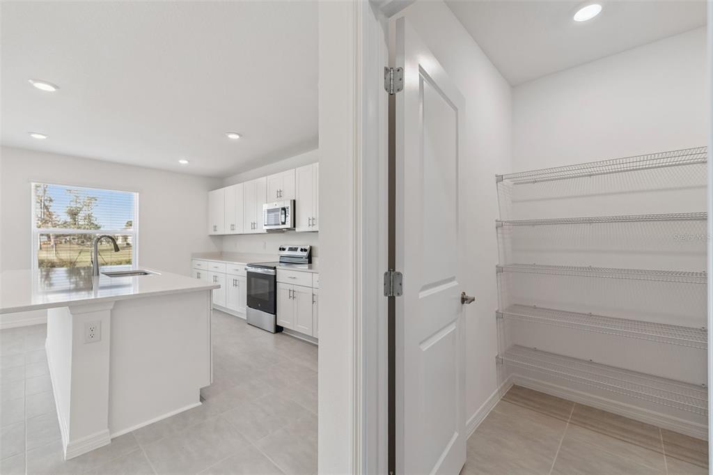 188 Jones Fish Camp Road Edgewater, FL 32141 - Photo 11 of 34 a kitchen with white cabinets and white appliances