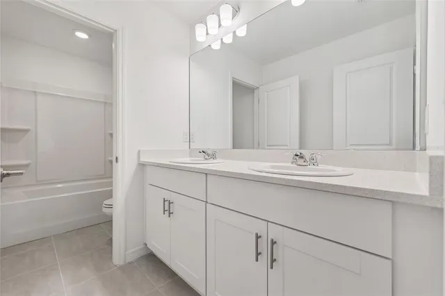 a bathroom with a sink a mirror and a bathtub with shower