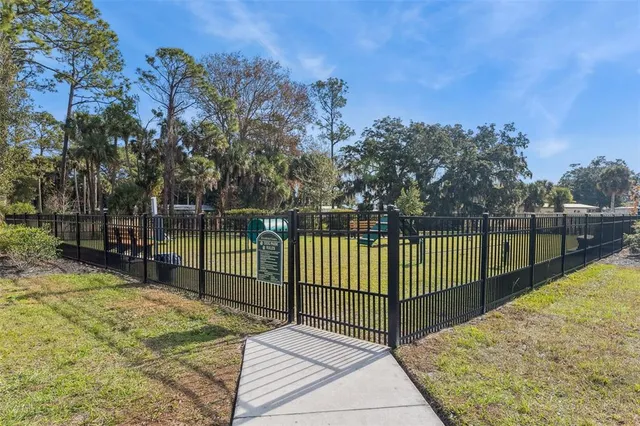a view of a backyard with iron fence