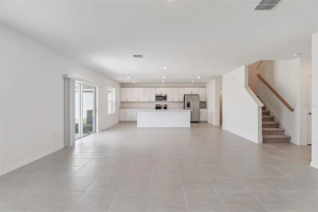 a view of a livingroom with furniture and an empty room