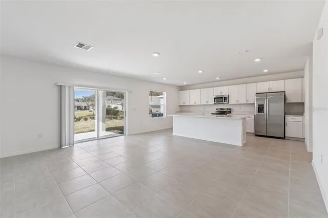 a view of a kitchen with a sink and a refrigerator