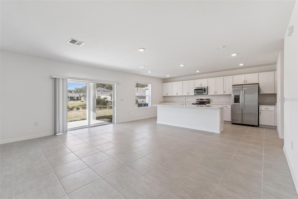 188 Jones Fish Camp Road Edgewater, FL 32141 - Photo 5 of 34 a view of a kitchen with a sink and a refrigerator
