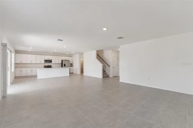 a view of a kitchen with a sink and white cabinets