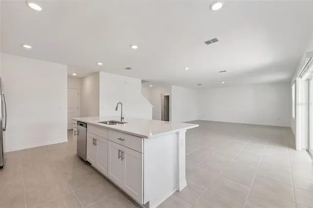 a kitchen with a sink and a stove top oven