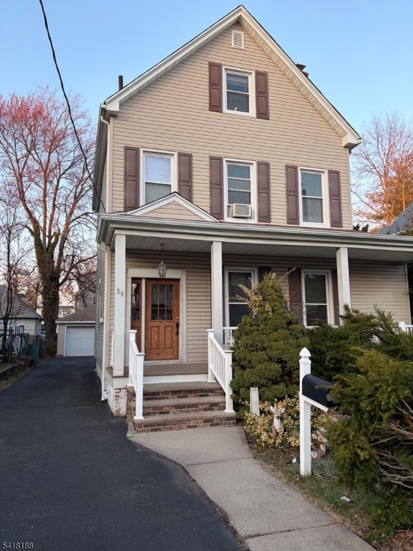 a front view of a house with plants