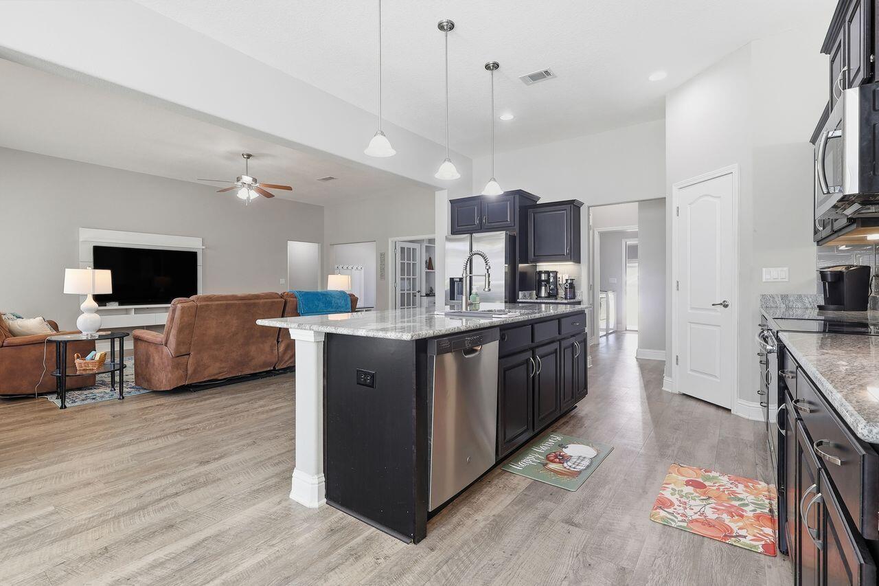 3025 Crown Creek Circle Crestview, FL 32539 - Photo 14 of 46 a large kitchen with stainless steel appliances granite countertop a stove and a sink