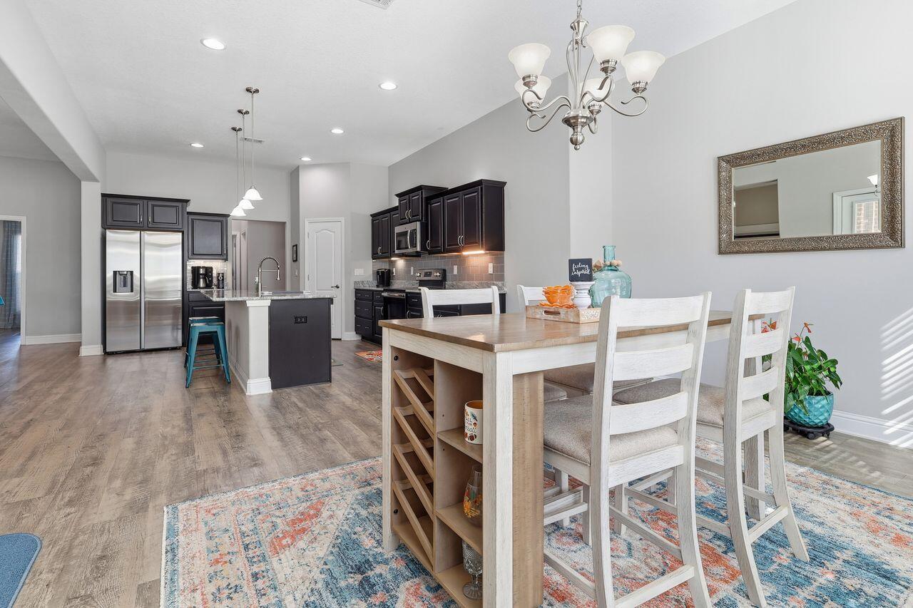 3025 Crown Creek Circle Crestview, FL 32539 - Photo 17 of 46 a kitchen with stainless steel appliances kitchen island granite countertop a refrigerator and a stove top oven