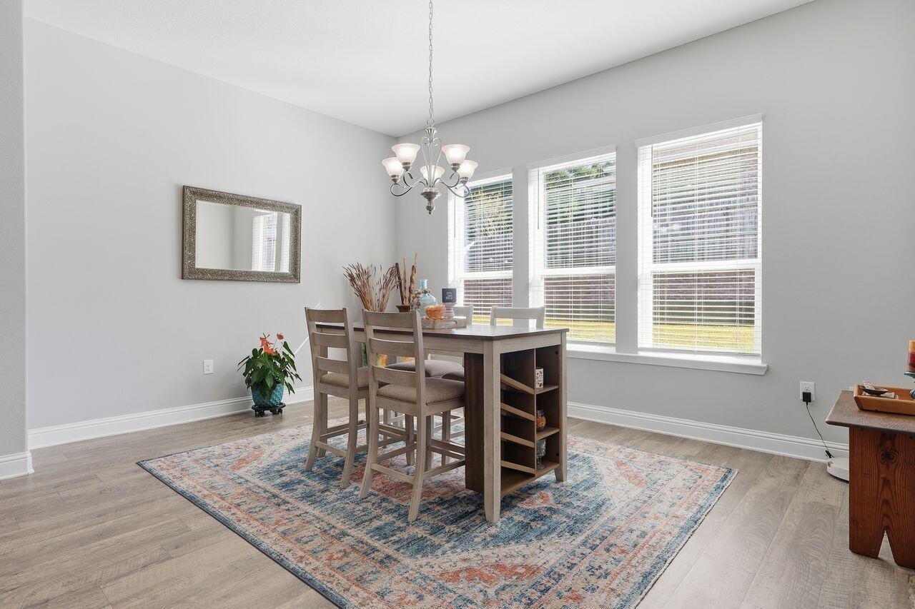 3025 Crown Creek Circle Crestview, FL 32539 - Photo 19 of 46 a view of a dining room with furniture window and wooden floor