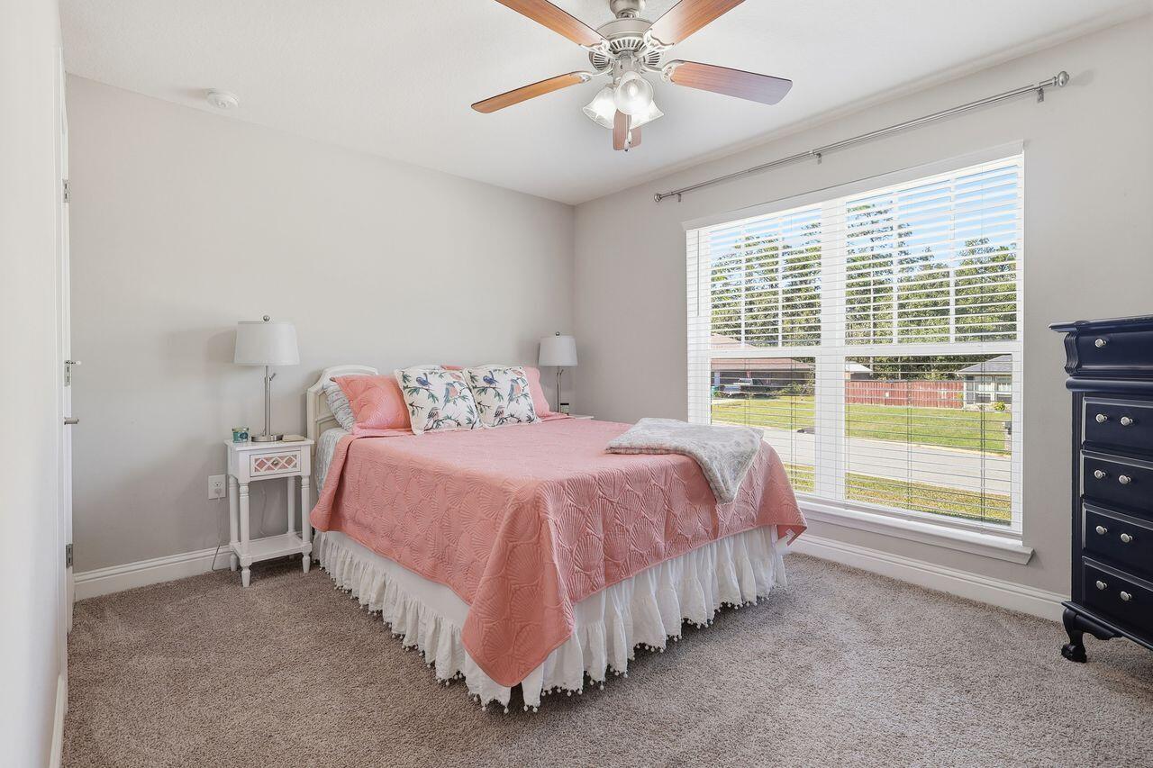 3025 Crown Creek Circle Crestview, FL 32539 - Photo 26 of 46 a spacious bedroom with a bed and a large window