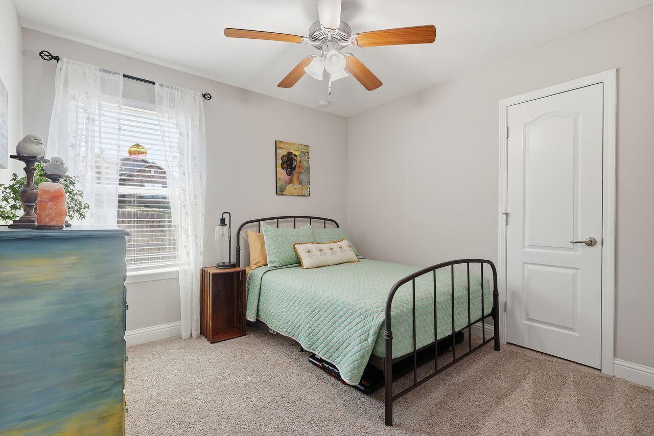 3025 Crown Creek Circle Crestview, FL 32539 - Photo 28 of 46 a bedroom with a bed and a chandelier