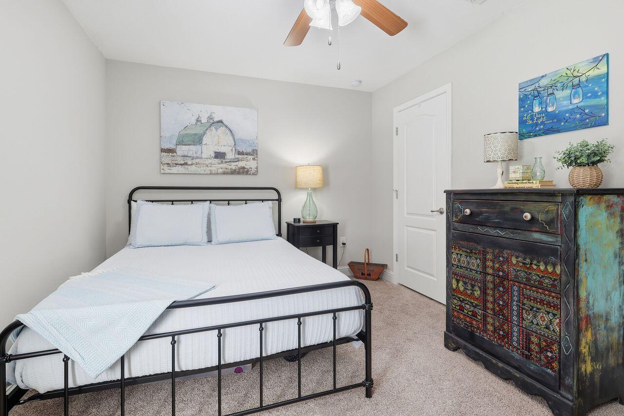 3025 Crown Creek Circle Crestview, FL 32539 - Photo 30 of 46 a bedroom with a bed and a lamp on a dresser