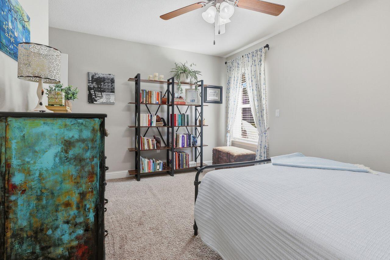 3025 Crown Creek Circle Crestview, FL 32539 - Photo 32 of 46 a bedroom with a bed and a mirror