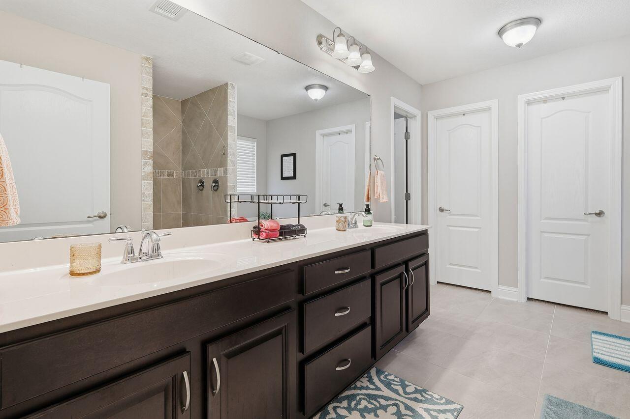 3025 Crown Creek Circle Crestview, FL 32539 - Photo 34 of 46 a bathroom with double vanity sinks and a mirror