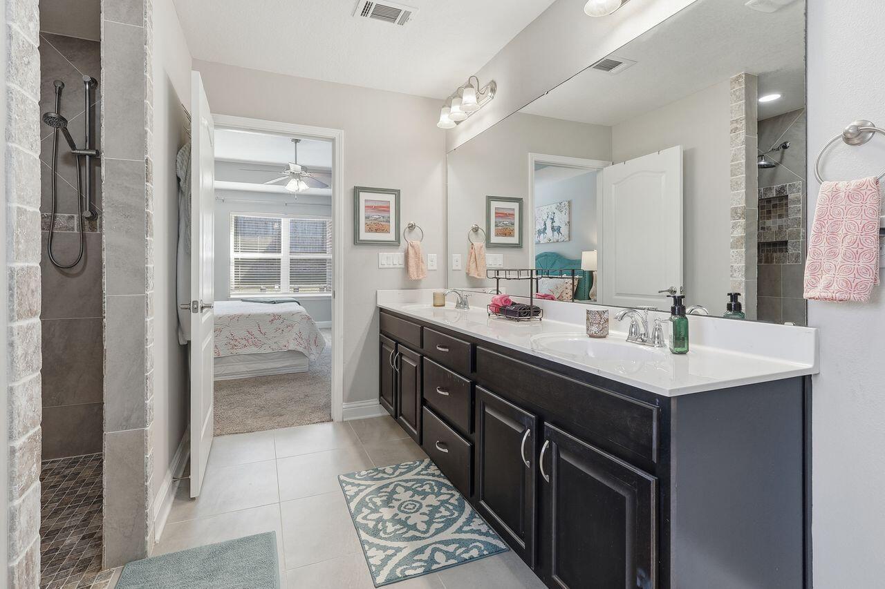 3025 Crown Creek Circle Crestview, FL 32539 - Photo 38 of 46 a bathroom with a sink double vanity and a mirror