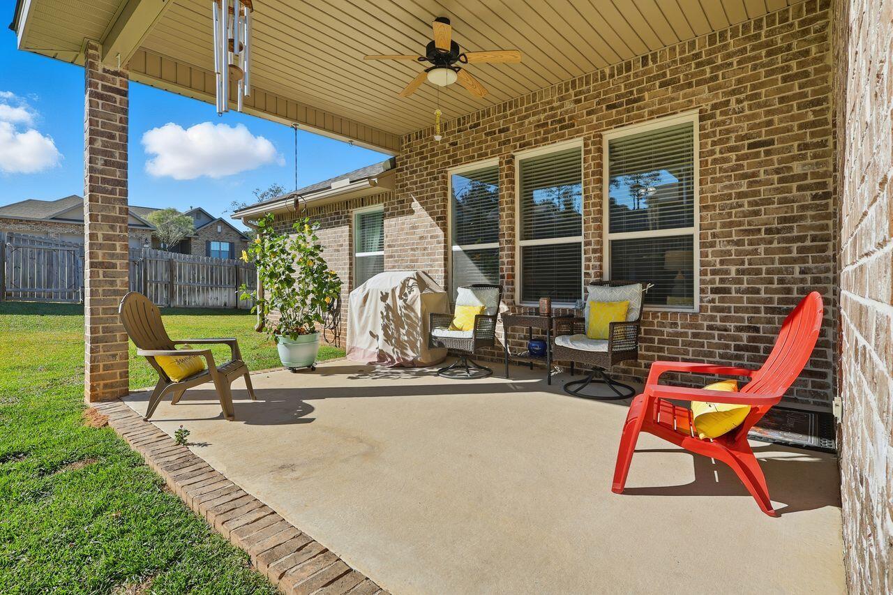 3025 Crown Creek Circle Crestview, FL 32539 - Photo 39 of 46 a view of a patio with a table and chairs