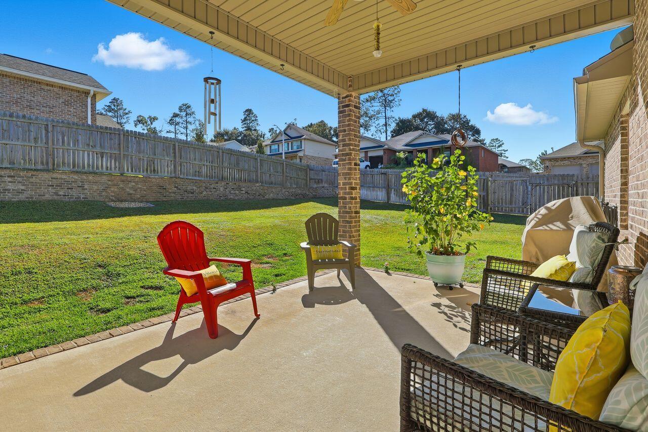 3025 Crown Creek Circle Crestview, FL 32539 - Photo 40 of 46 a view of a chairs and table in patio