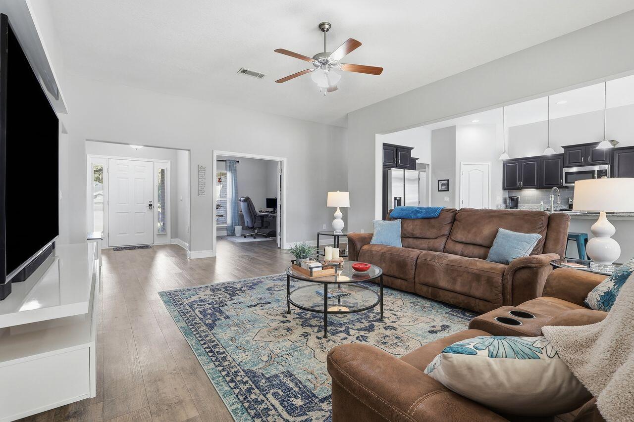 3025 Crown Creek Circle Crestview, FL 32539 - Photo 8 of 46 a living room with furniture and wooden floor