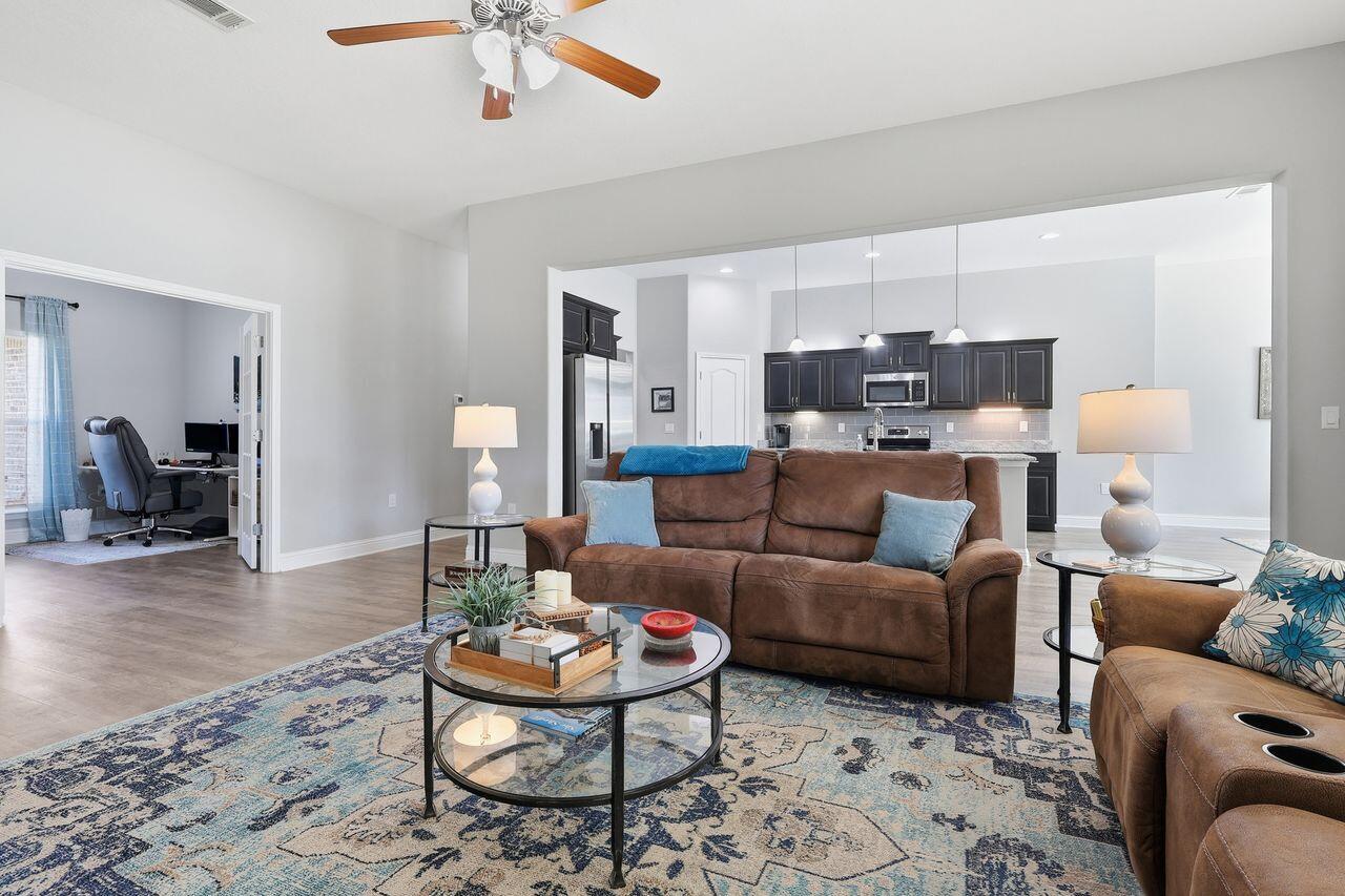 3025 Crown Creek Circle Crestview, FL 32539 - Photo 10 of 46 a living room with furniture and a wooden floor