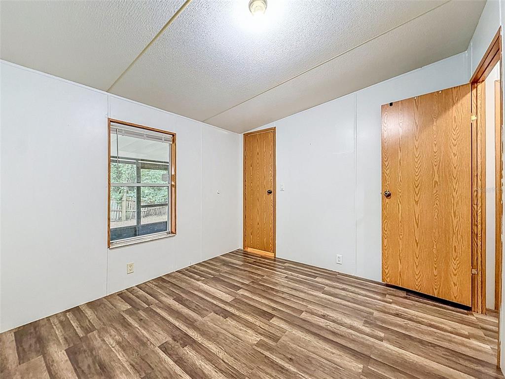 1819 Sinclair Hills Road Lutz, FL 33549 - Photo 47 of 60 a view of an empty room with wooden floor and a window