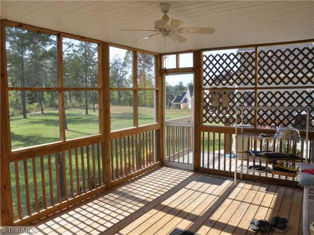 5043 Peppertree Road Clemmons, NC 27012 - Photo 14 of 16 Enclosed Porch. Relax on the screened porch overlooking the wooded back yard.