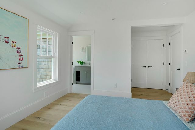 an empty room with cabinet and windows