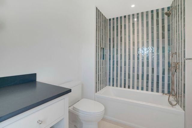 a bathroom with a toilet and a bathtub