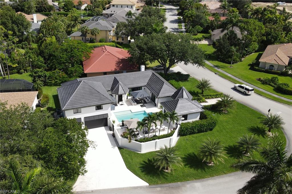 an aerial view of a house with a garden and lake view