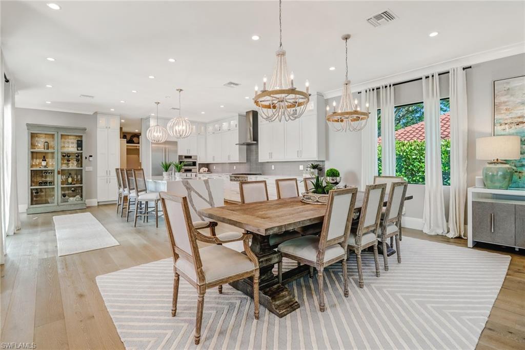 1919 Manchester Circle Naples, FL 34109 - Photo 45 of 45 a dining room with furniture window and wooden floor