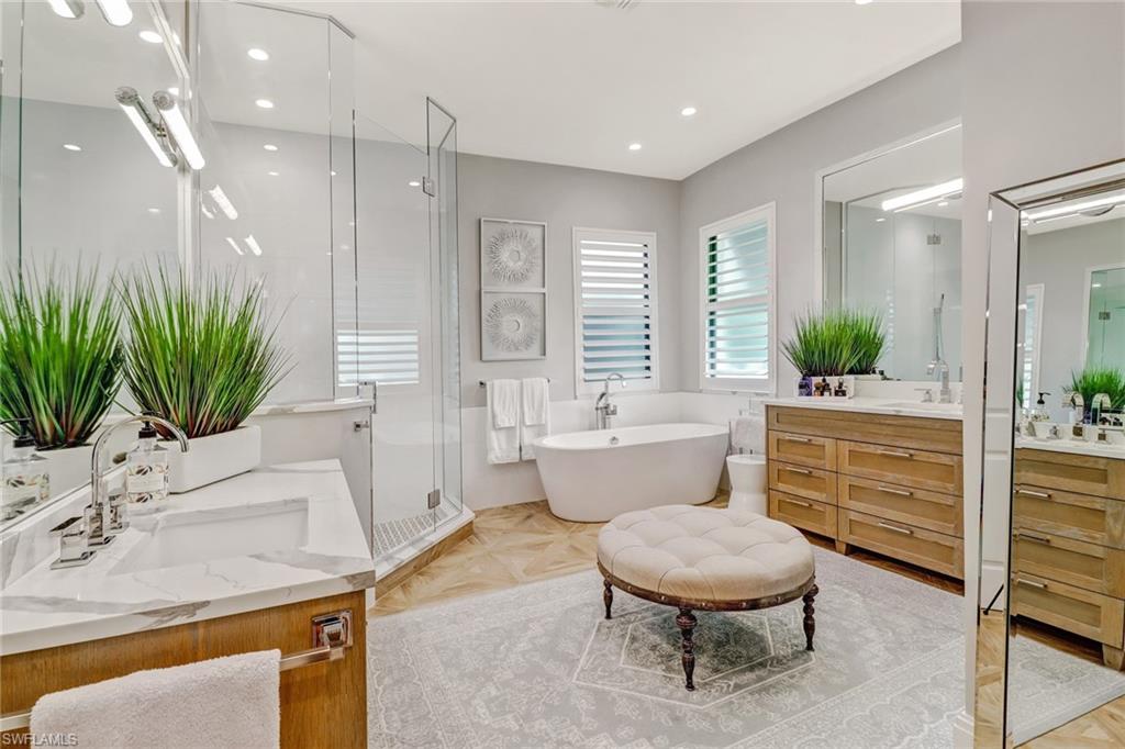 1919 Manchester Circle Naples, FL 34109 - Photo 15 of 45 a bathroom with a sink a toilet a mirror and shower