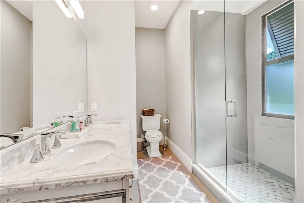 1919 Manchester Circle Naples, FL 34109 - Photo 17 of 45 a bathroom with a sink and a mirror