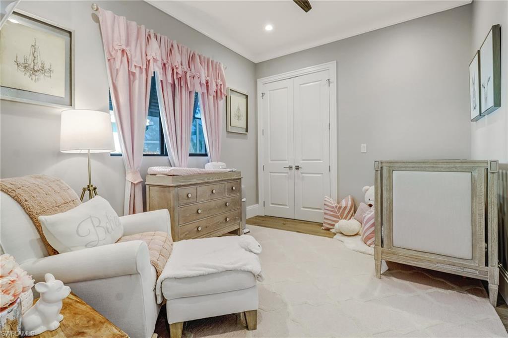 1919 Manchester Circle Naples, FL 34109 - Photo 18 of 45 a living room with furniture and a flat screen tv