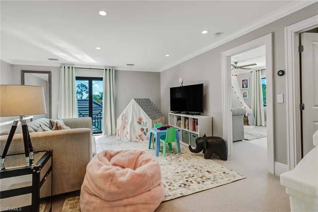 1919 Manchester Circle Naples, FL 34109 - Photo 21 of 45 a living room with furniture and a flat screen tv