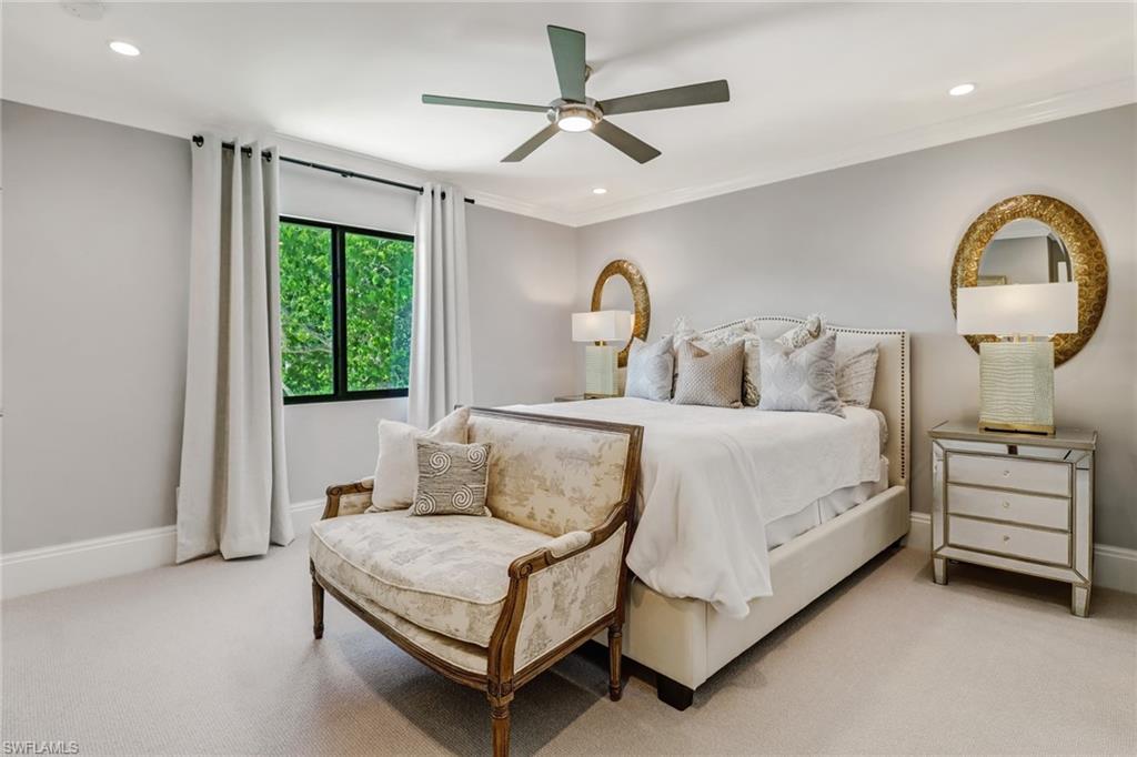 1919 Manchester Circle Naples, FL 34109 - Photo 23 of 45 a bedroom with a bed mirror and window