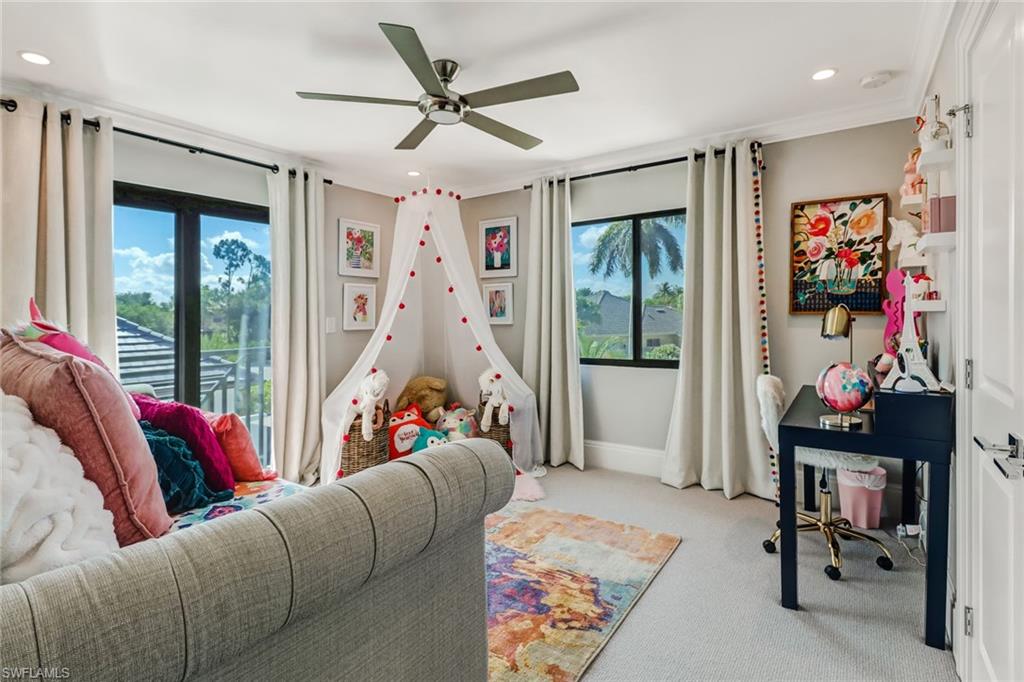 1919 Manchester Circle Naples, FL 34109 - Photo 26 of 45 a living room with furniture ceiling fan and a rug