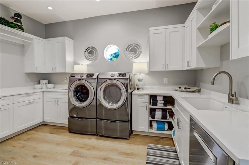1919 Manchester Circle Naples, FL 34109 - Photo 29 of 45 a utility room with sink dryer and washer