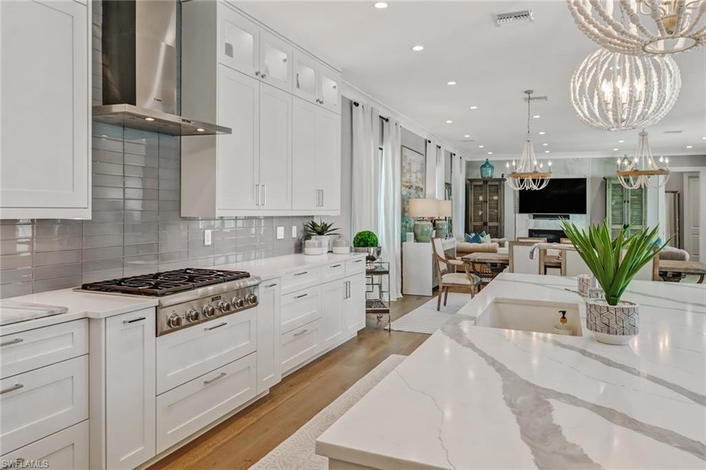 1919 Manchester Circle Naples, FL 34109 - Photo 4 of 45 a kitchen with stainless steel appliances kitchen island granite countertop a stove a sink a refrigerator and a white cabinets