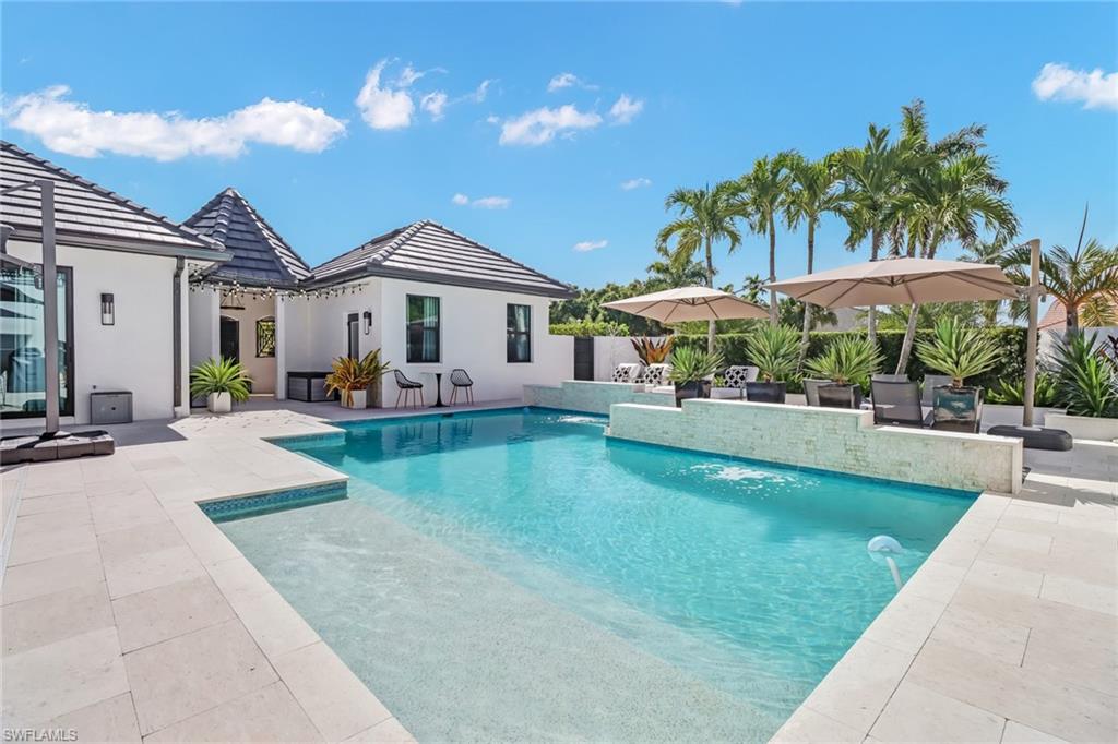 1919 Manchester Circle Naples, FL 34109 - Photo 40 of 45 a view of a house with swimming pool and sitting area