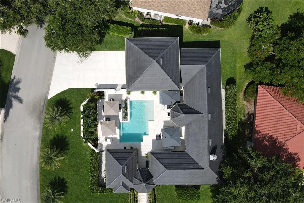 1919 Manchester Circle Naples, FL 34109 - Photo 41 of 45 an aerial view of a house with a garden and trees