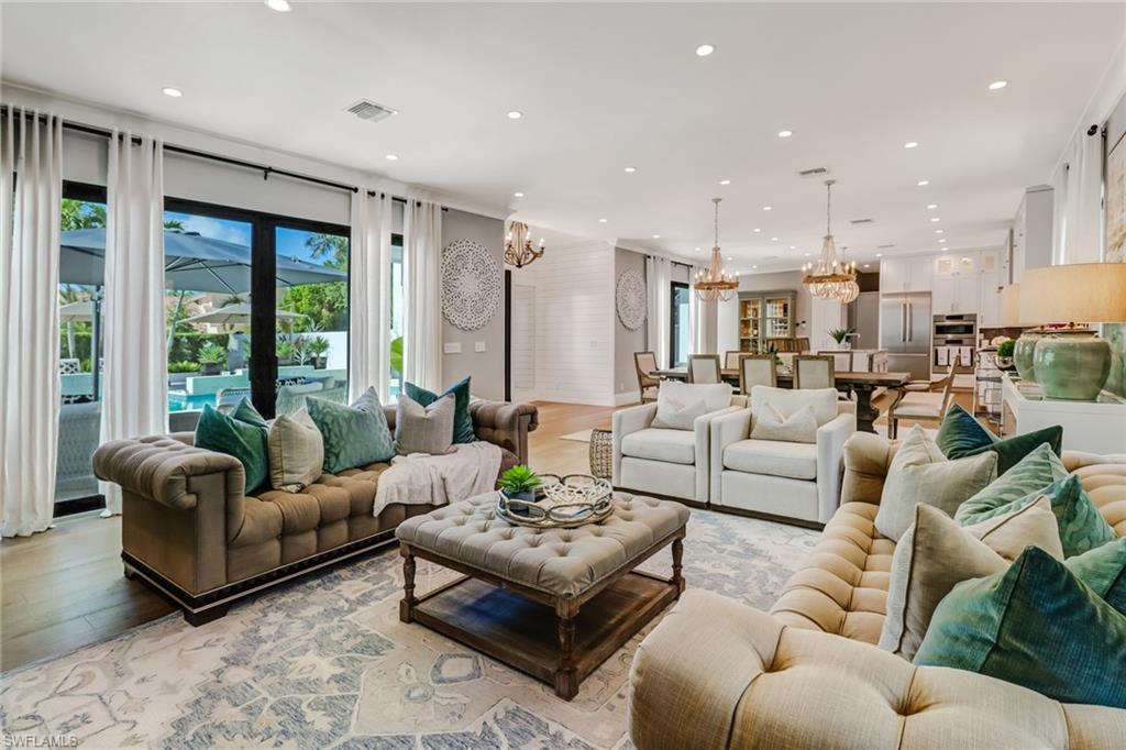 1919 Manchester Circle Naples, FL 34109 - Photo 6 of 45 a living room with furniture kitchen view and a large window