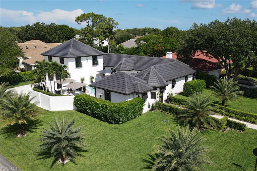 1919 Manchester Circle Naples, FL 34109 - Photo 7 of 45 a house with lots of trees in the background