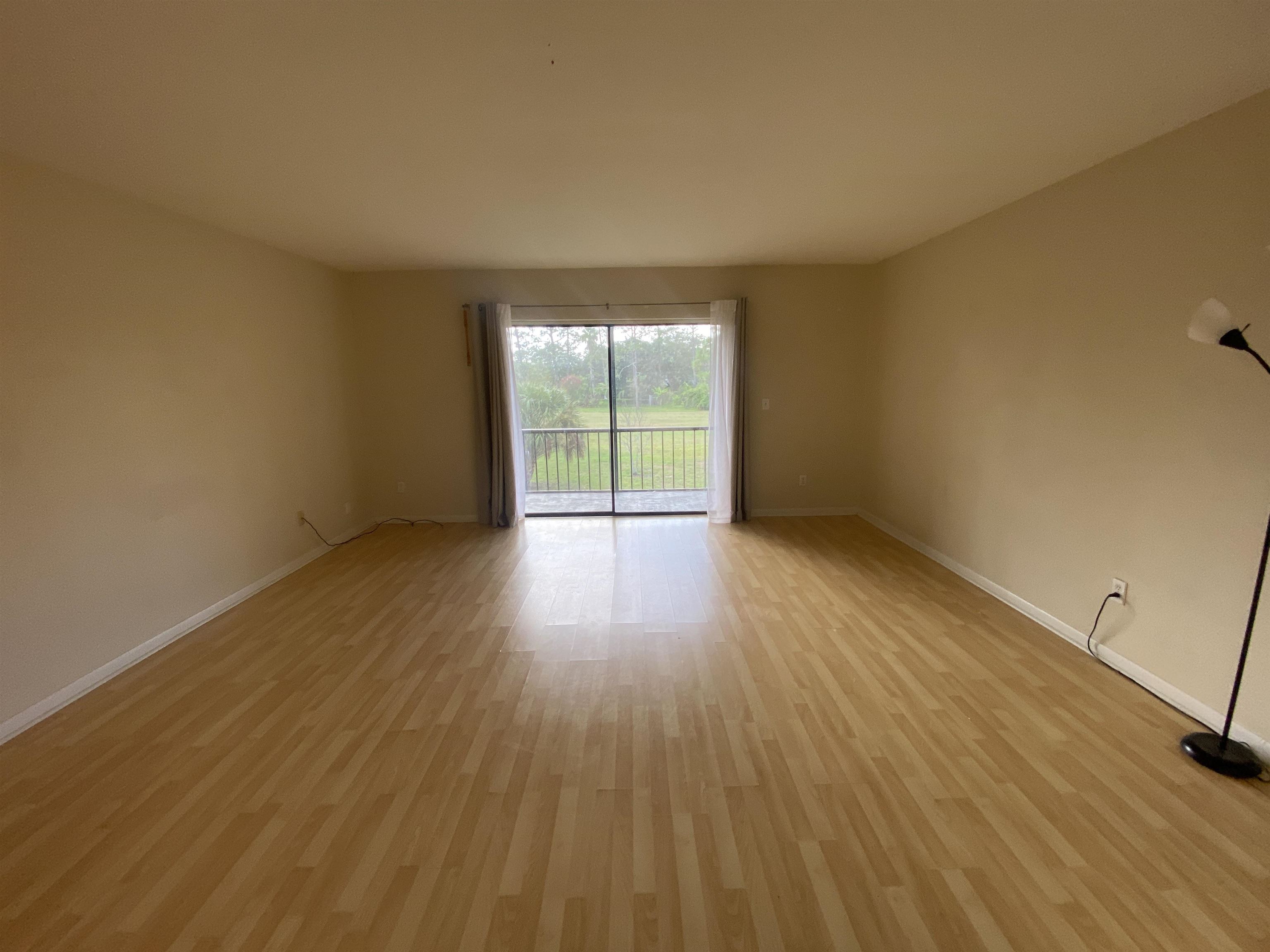 600 Domenico Circle, Unit C16 St. Augustine, FL 32086 - Photo 12 of 23 a view of an empty room with wooden floor and a window
