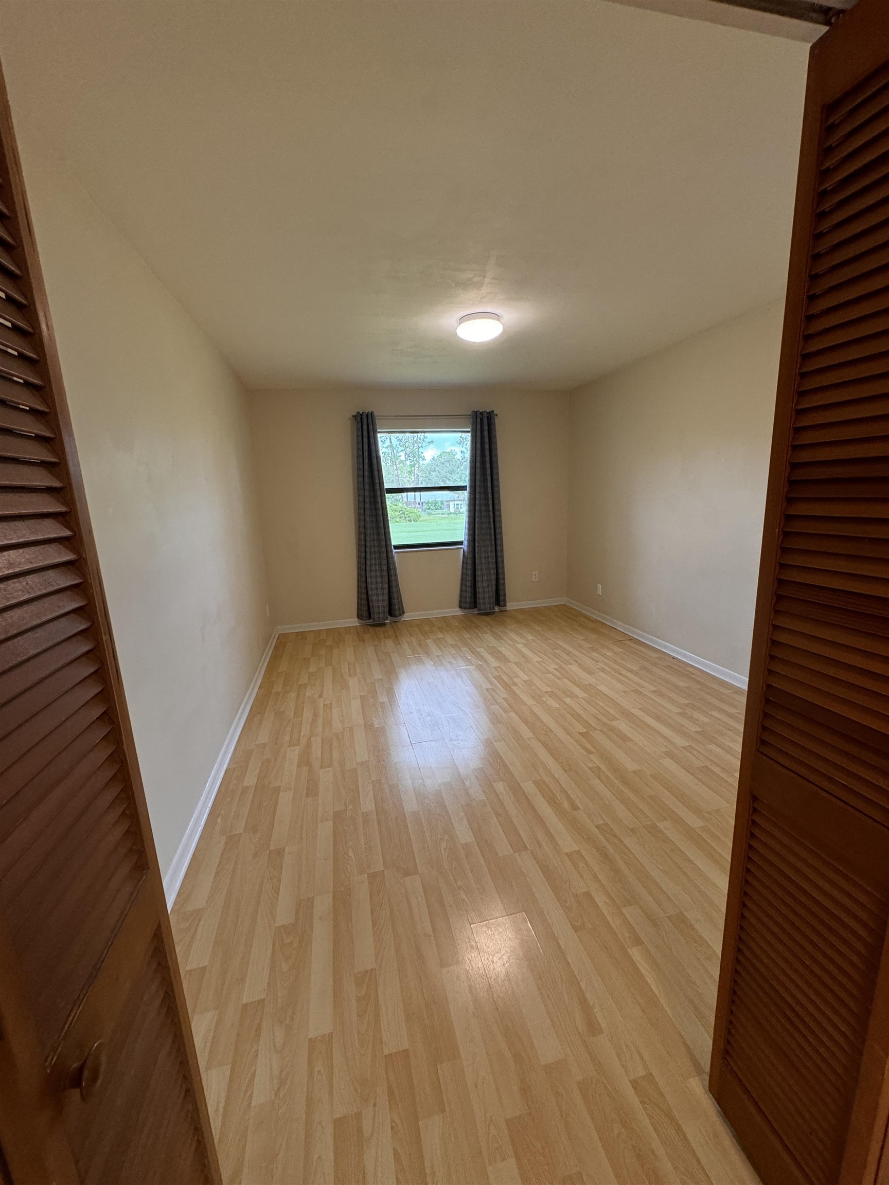 600 Domenico Circle, Unit C16 St. Augustine, FL 32086 - Photo 14 of 23 wooden floor in an empty room with a window