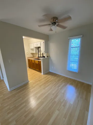 a view of a kitchen with a stove wooden floor and a kitchen space