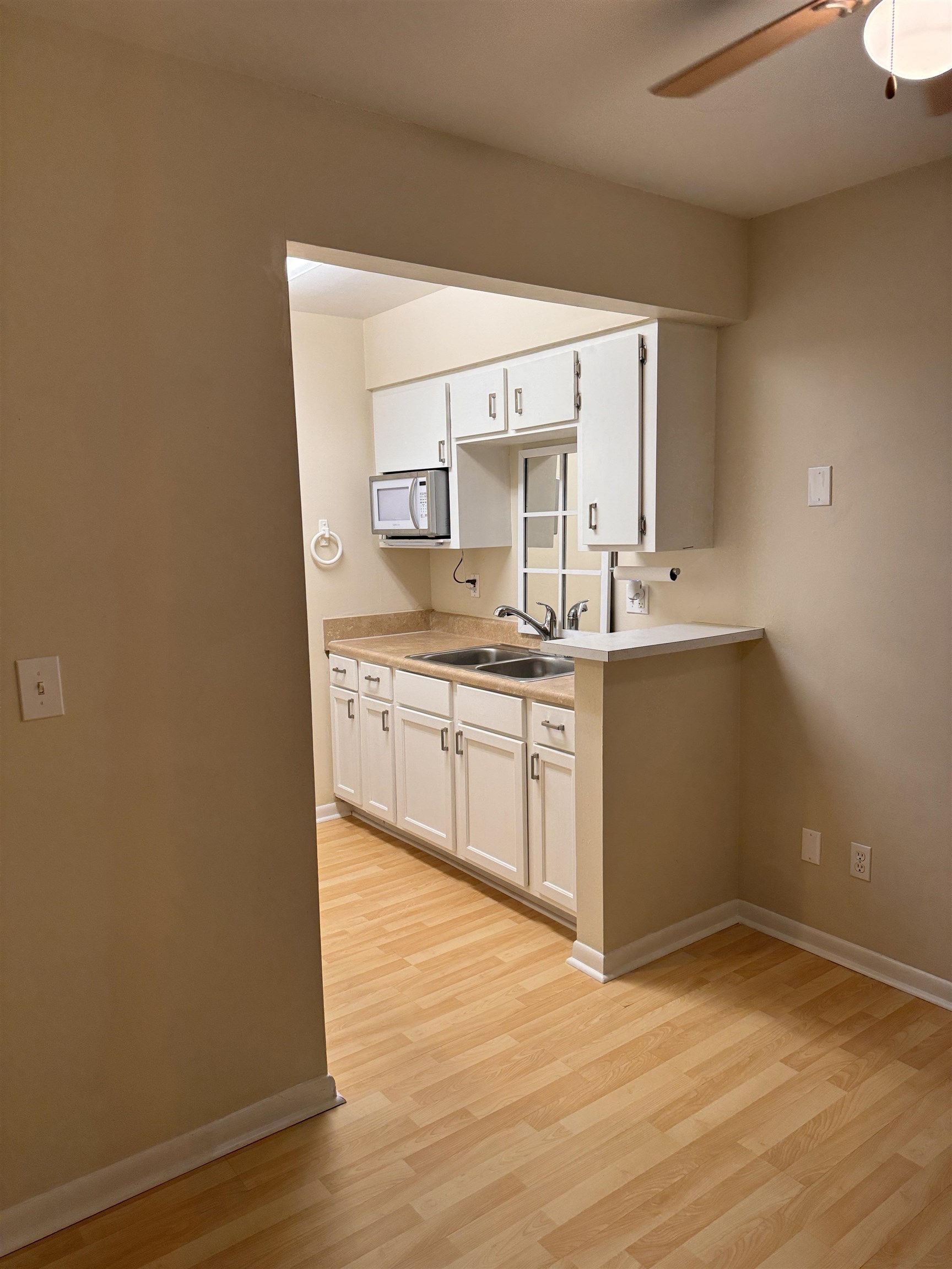 600 Domenico Circle, Unit C16 St. Augustine, FL 32086 - Photo 9 of 23 a kitchen with a sink cabinets and wooden floor