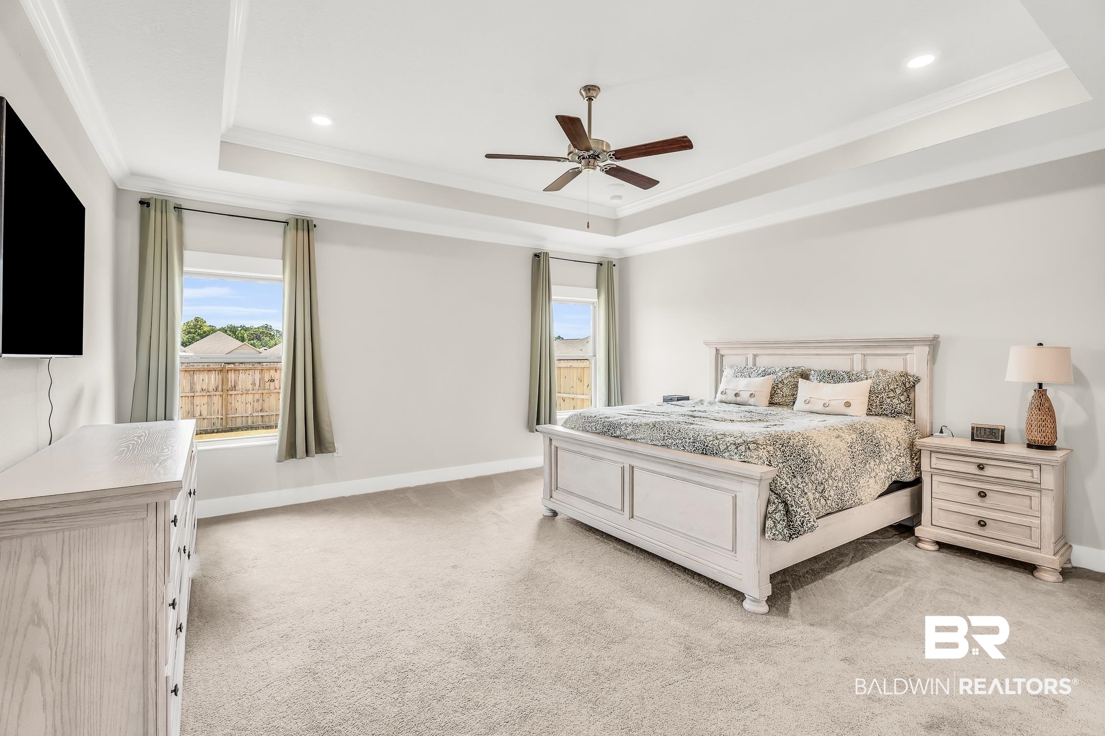 1720 Partridge Street Foley, AL 36535 - Photo 15 of 32 Carpeted bedroom with ceiling fan, a tray ceiling, and ornamental molding