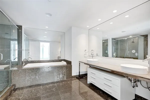 a bathroom with a toilet a sink a mirror and vanity