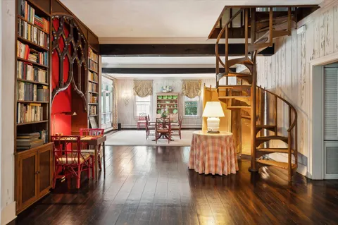 a view of a living room with furniture and wooden floor